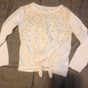 3t girl off white top with gold stars and a tie